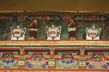 Colorful design elements above a doorway include small lion sculptures